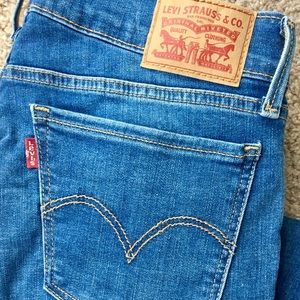 Levi 710 Super Skinny jeans, size 28, medium wash.